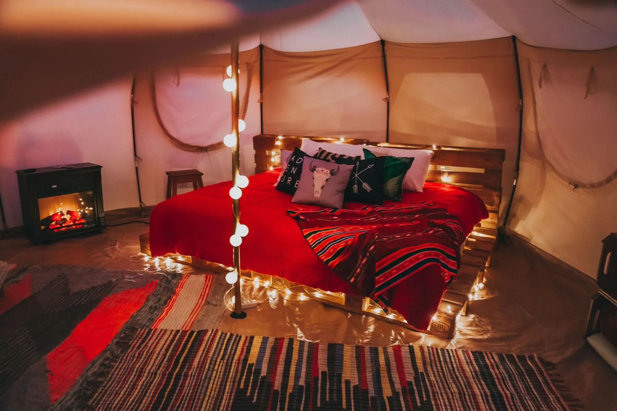 A bell tent, lit warm.